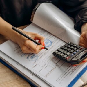Hands holding pencil and calculator